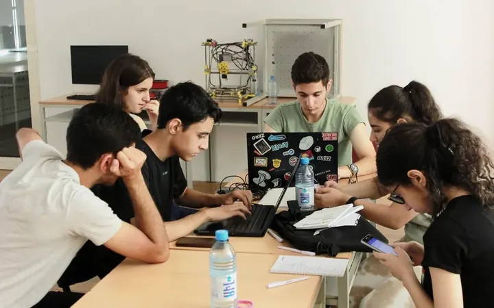 DigiCamp participants coding together at a table