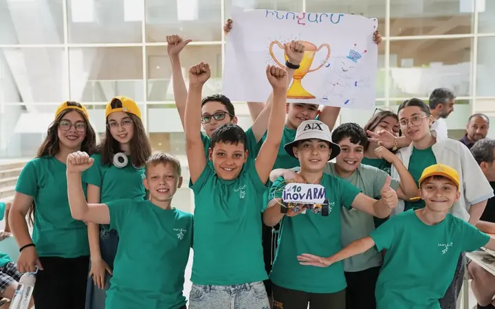 A Techno Camp team cheering with their trophy